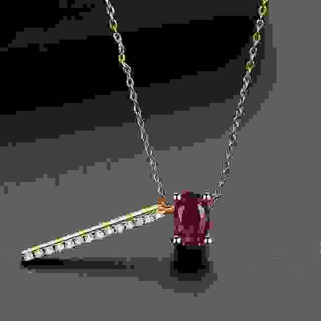 Red diamond necklace with a moonstone pendant featuring copper inlay, delicate chain with small gemstones, elegant jewelry piece