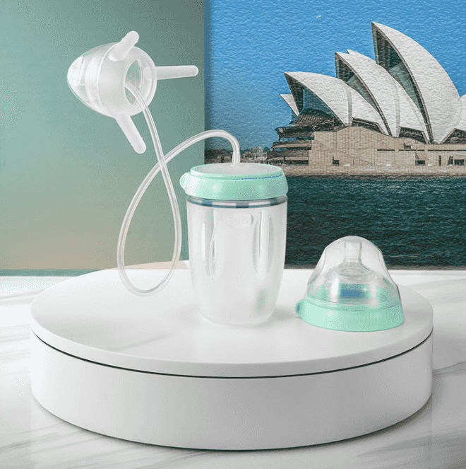 Silicone sippy training cup for kids with a transparent body, mint green lid, and straw, ideal for toddler hydration and learning