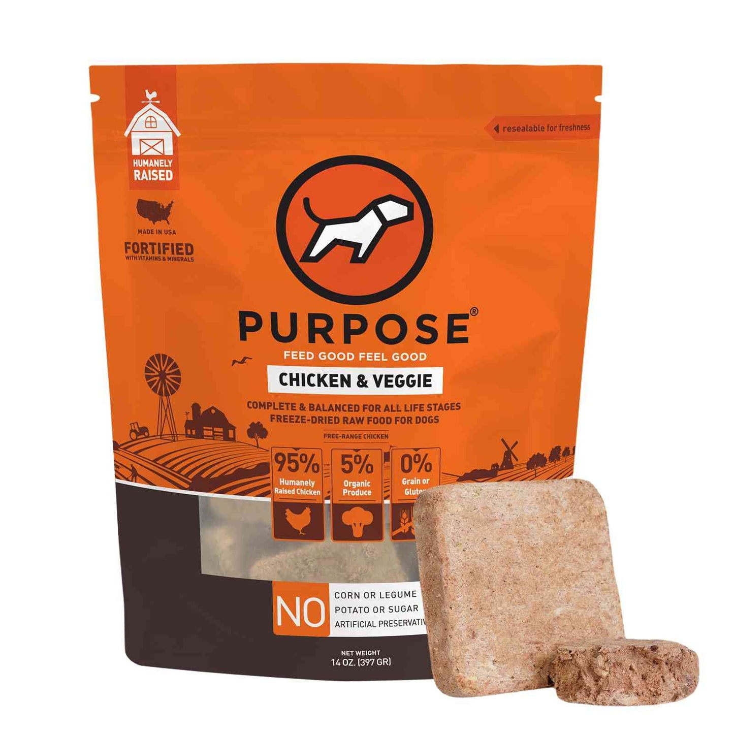 Close-up of freeze dried dog food cube in front of orange PURPOSE dog food bag, highlighting natural ingredients and grain-free label