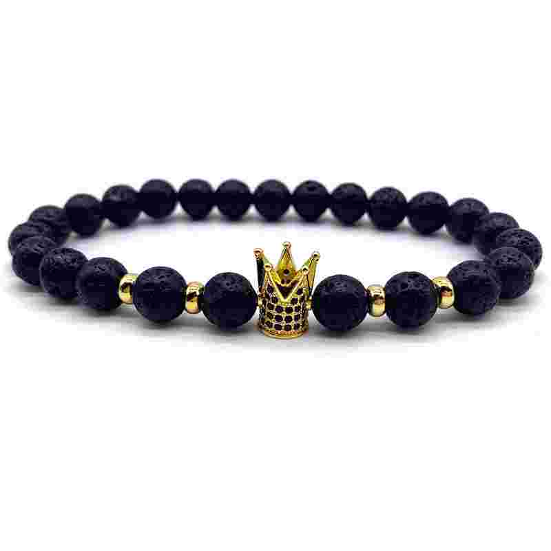 Black volcanic stone beaded stretch bracelet with gold crown charm, featuring 8mm textured beads and gold spacer accents, stylish jewelry accessory.