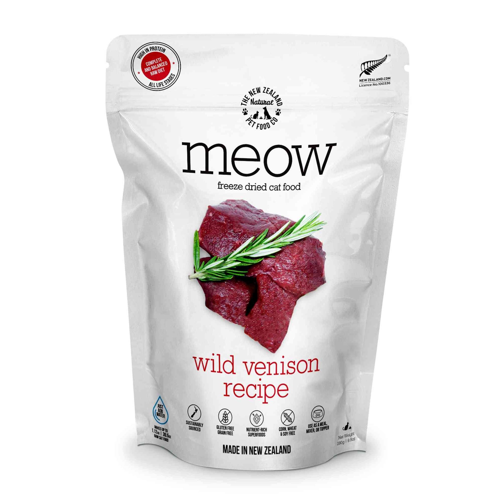 White resealable bag of freeze dried cat food with black text and red accents, featuring a picture of raw venison and green herbs, made in New Zealand