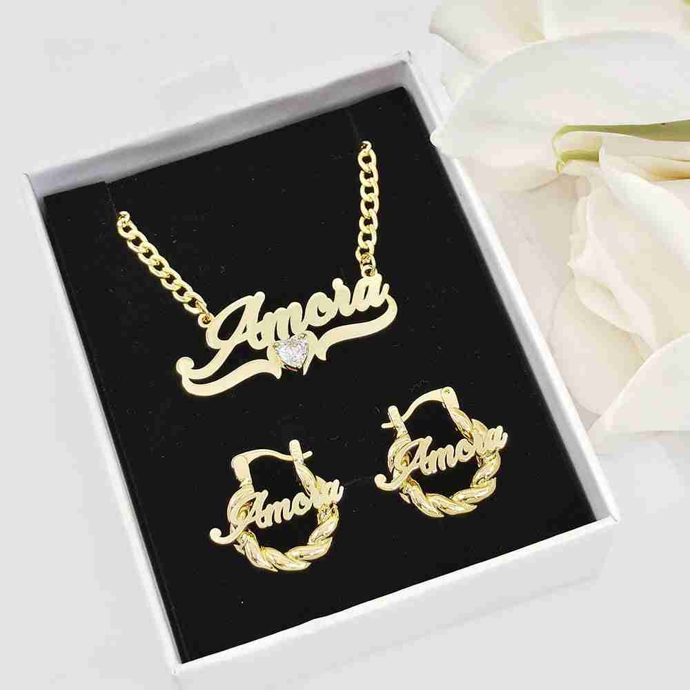 Gold chain bracelet with personalized name tag 'AngelDani' and a small heart-shaped gemstone, stylish accessory for women