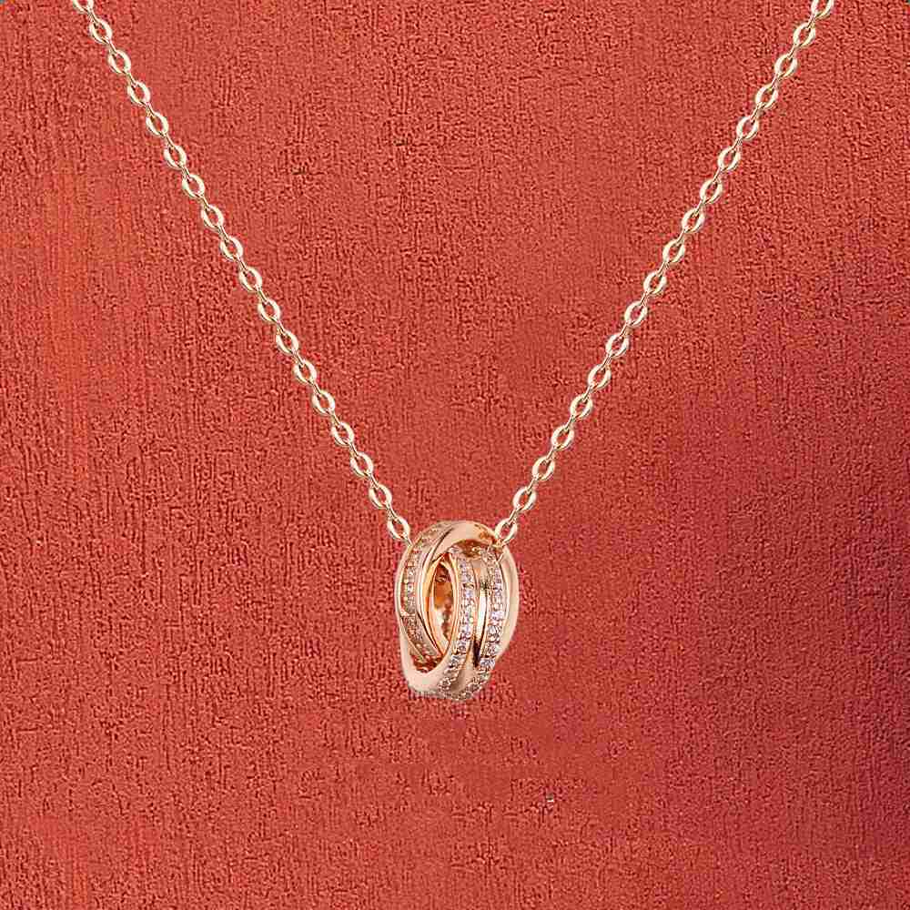 Silver and rose gold-tone double ring necklaces displayed on a jewelry pouch, elegant accessories for women